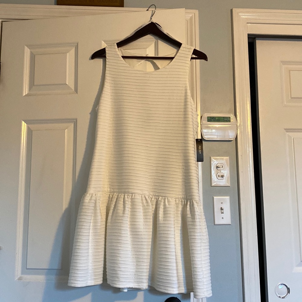 White textured dress with trumpet bottom and peekaboo back